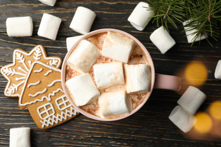 Cup with marshmallow on wooden background with Christmas accessoriesの写真素材