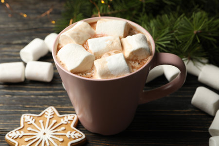 Cup with marshmallow on wooden background with Christmas accessoriesの写真素材