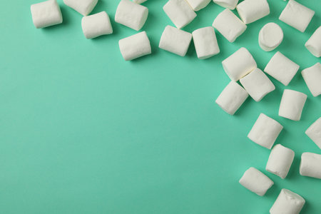 Sweet marshmallow on mint background, space for textの写真素材