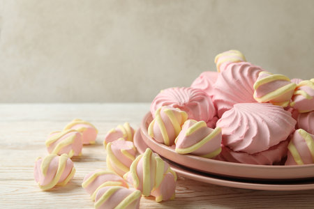 Plate with sweet marshmallow on wooden backgroundの写真素材