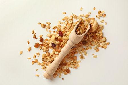 Wooden scoop and granola on white backgroundの写真素材