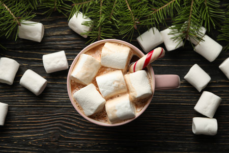 Cup with marshmallow on wooden background with Christmas accessoriesの写真素材