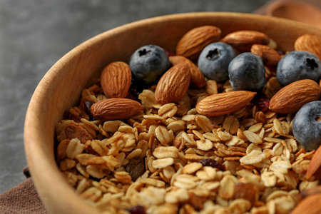 Wooden bowl with tasty granola, close upの写真素材
