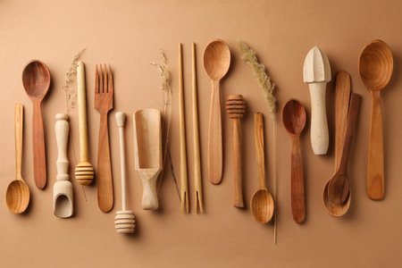 Different wooden cutlery on beige background, top viewの写真素材