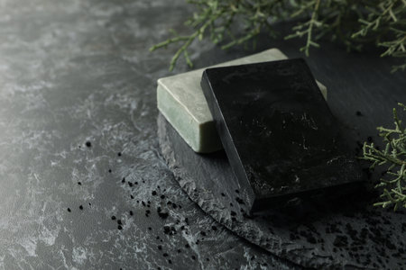 Tray with natural handmade soap on black smokey backgroundの写真素材