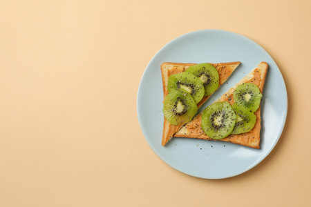 Plate with toasts with kiwi on beige backgroundの写真素材
