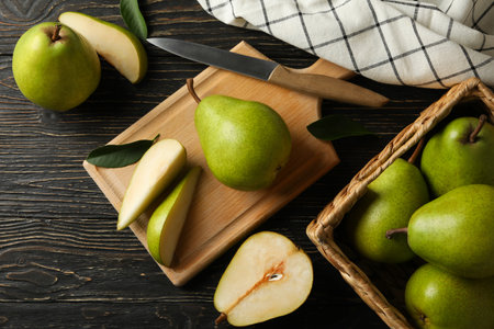 Board and basket with green pears on wooden backgroundの写真素材