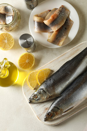 Concept of tasty lunch with fresh herring fish on white textured backgroundの写真素材