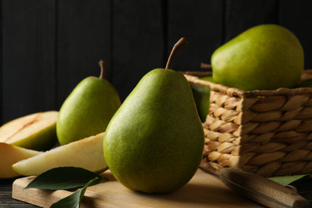 Board and basket with green pears on wooden backgroundの写真素材