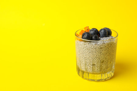 Glass of delicious chia pudding on yellow backgroundの写真素材