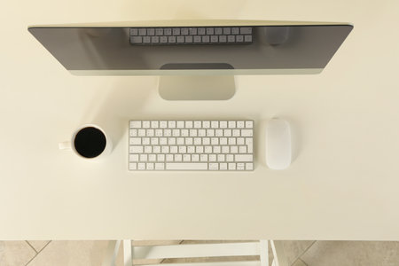 Minimalist workspace concept with desktop computer on white tableの写真素材