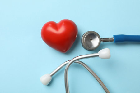Blue stethoscope and heart on blue backgroundの写真素材