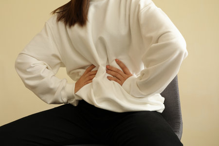 Woman in stylish sweatshirt sitting on chairの写真素材
