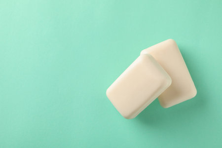 Pieces of natural handmade soap on mint backgroundの写真素材
