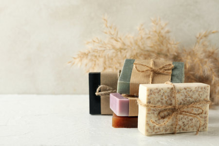 Reed branches and natural soap on white tableの写真素材