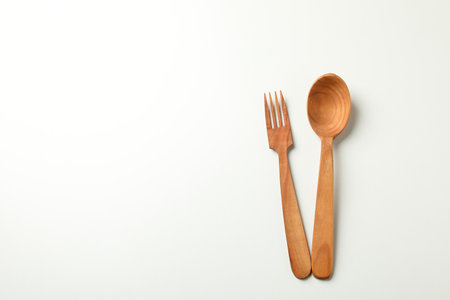 Wooden spoon and knife on white background, space for textの写真素材