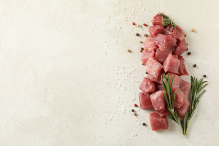 Raw meat with herbs and spices on white textured backgroundの写真素材
