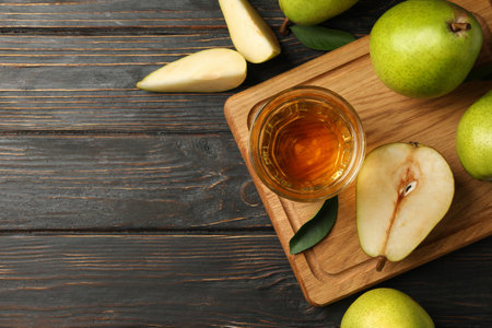 Board with fresh green pears and juice on wooden backgroundの写真素材