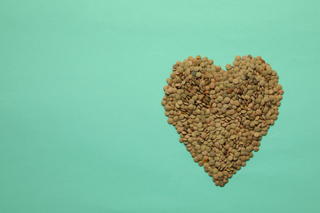 Heart made of legumes on mint backgroundの写真素材