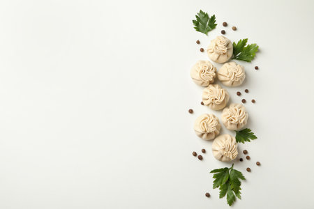 Raw khinkali, pepper and parsley on white backgroundの写真素材