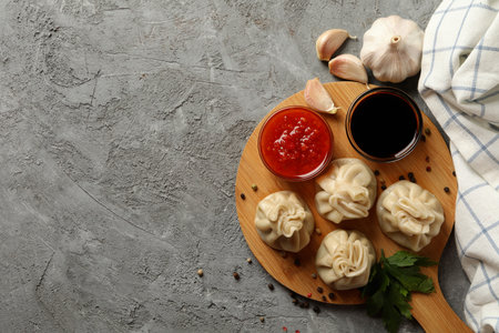 Concept of tasty lunch with board of khinkali on gray backgroundの写真素材