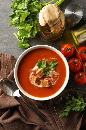 Concept of tasty food with tomato soup on dark wooden backgroundの写真素材
