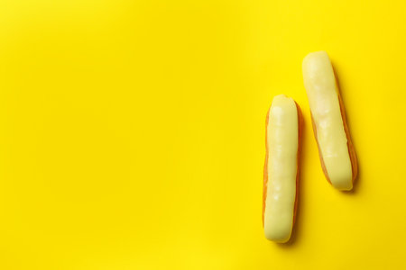 Delicious eclairs with custard on yellow backgroundの写真素材