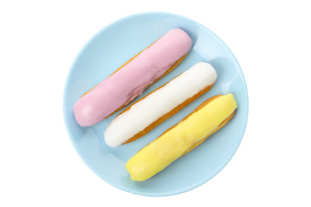 Plate with eclairs with custard isolated on white background