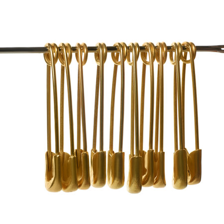 Golden safety pins isolated on white background, close upの写真素材
