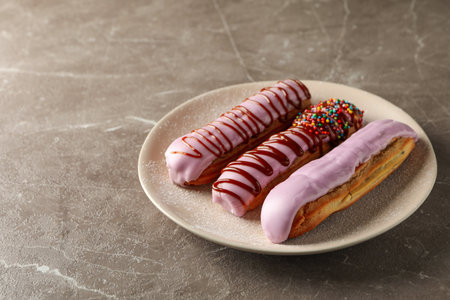 Plate with eclairs with custard on gray backgroundの写真素材