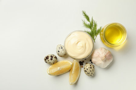 Bowl with mayonnaise and ingredients for cooking on white background, top viewの写真素材