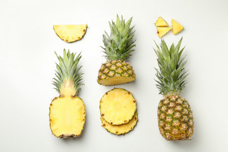 Flat lay with pineapple and slices on white backgroundの写真素材