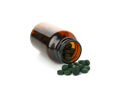 Medical bottle with spirulina pills isolated on white backgroundの写真素材