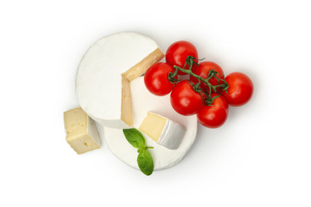 Camembert cheese, tomato and basil isolated on white backgroundの写真素材