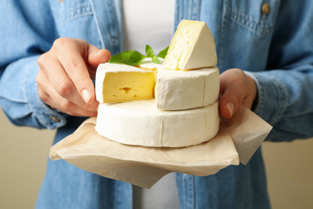 Woman hold baking paper with camembert, front viewの写真素材