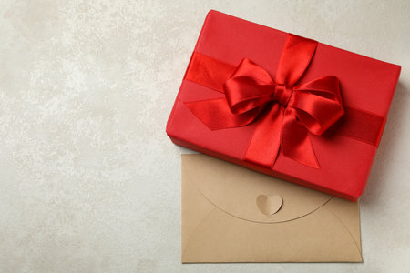 Gift box and envelope on white textured backgroundの写真素材