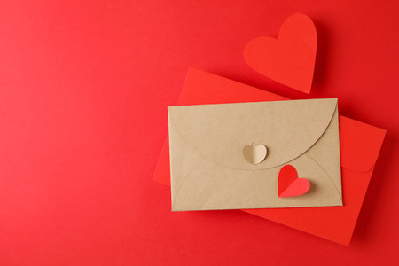 Envelopes and hearts on red background, space for text