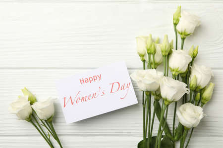 Roses and text Happy Women's Day on white wooden backgroundの写真素材