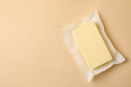 Paper with butter on beige background, space for textの写真素材