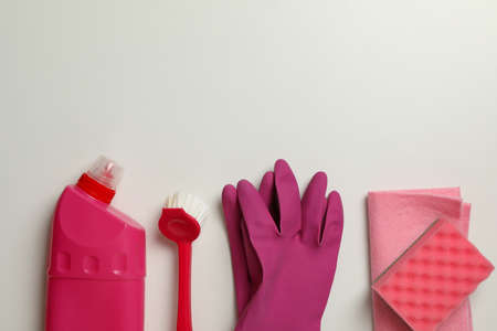 Different cleaning tools on white background, space for text