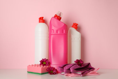 Cleaning tools and flowers on pink background, space for textの写真素材