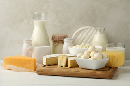 Different fresh dairy products on white wooden tableの写真素材
