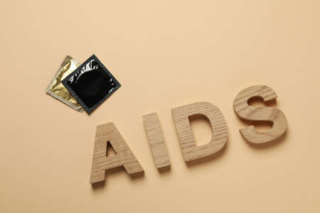 Word AIDS and condoms on beige backgroundの写真素材
