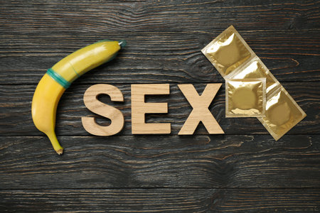 Word Sex, banana and condoms on wooden backgroundの写真素材