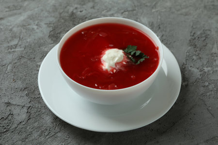 Bowl of tasty borscht on gray backgroundの写真素材