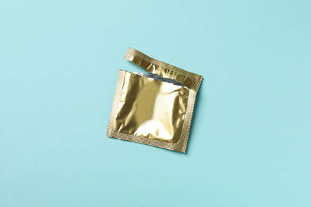 Empty blank condom packaging on blue backgroundの写真素材