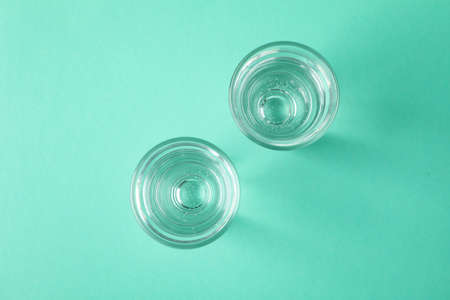 Shots of vodka or tequila on mint backgroundの写真素材