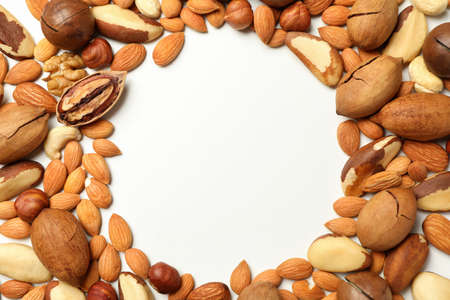 Different tasty nuts on white background, space for textの写真素材