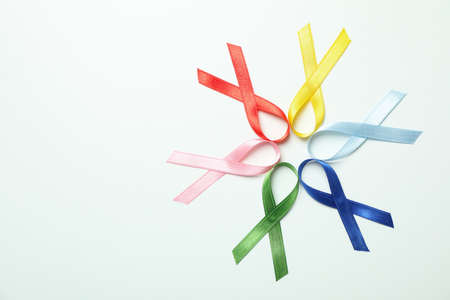 Different multi colored awareness ribbons on white background