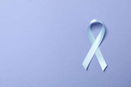 Light blue awareness ribbon on light violet background
